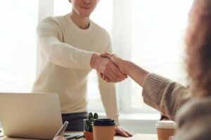 Two Professionals Shaking Hands During A Business Meeting. 