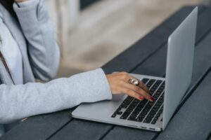 Woman Typing On Laptop