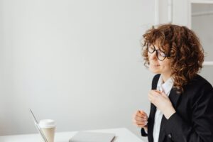 Woman Talking In Front Of Laptop
