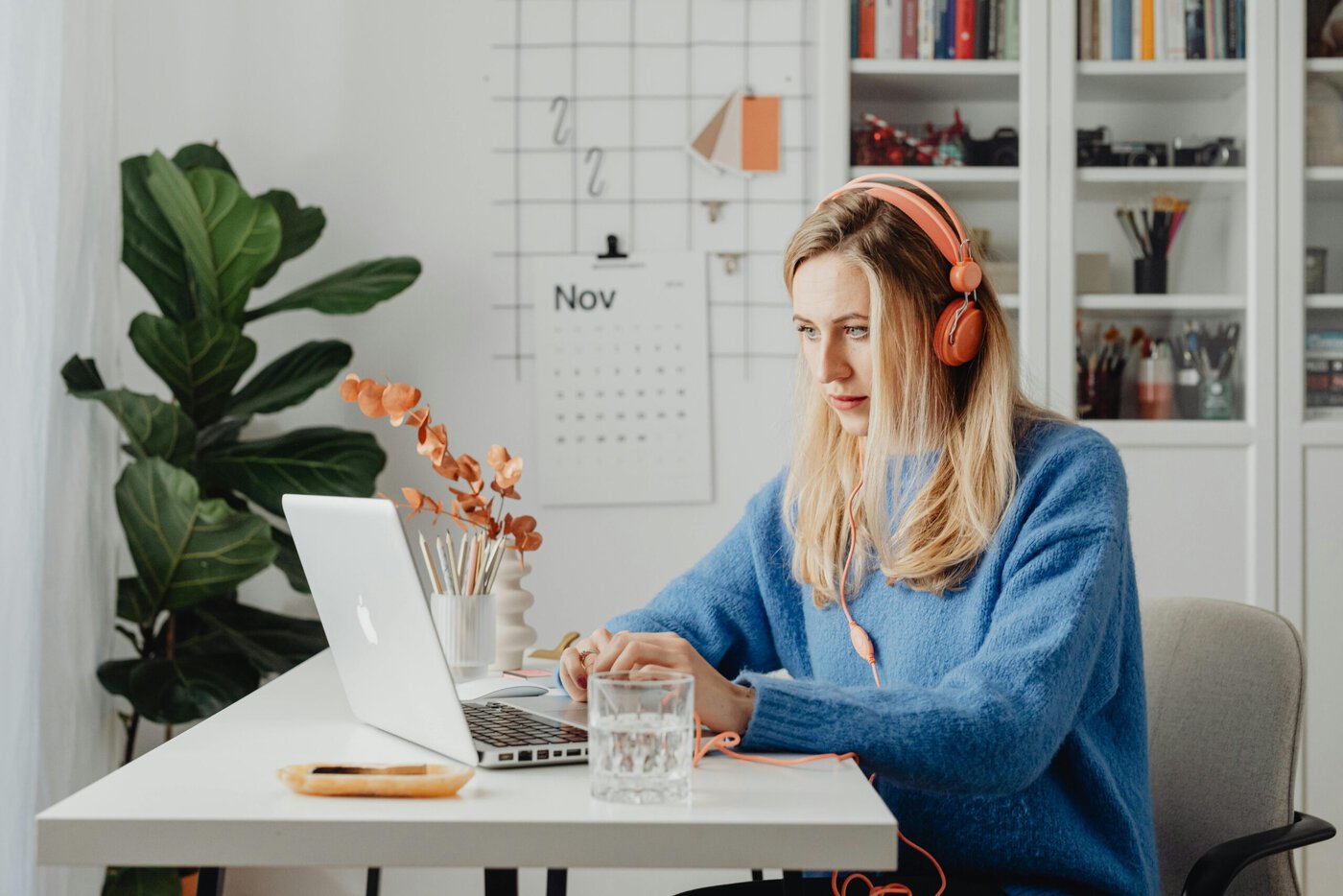 Woman In Blue Sweater Using Laptop