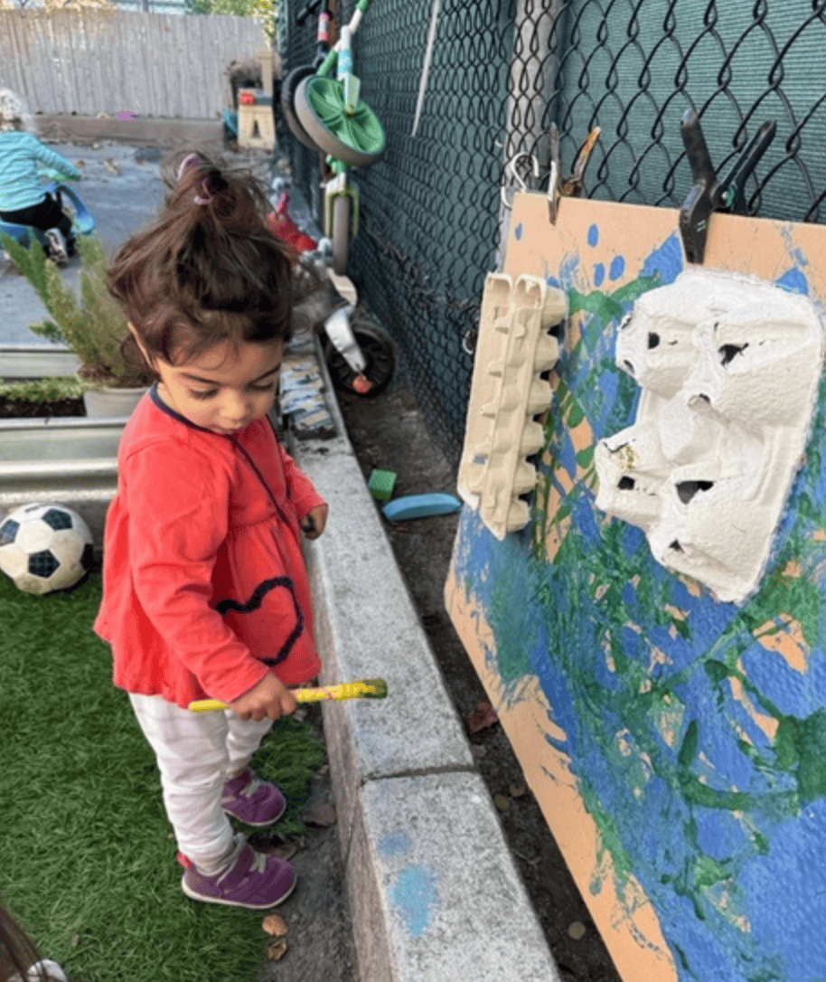Toddler Using Watercolors To Create A Colorful Painting