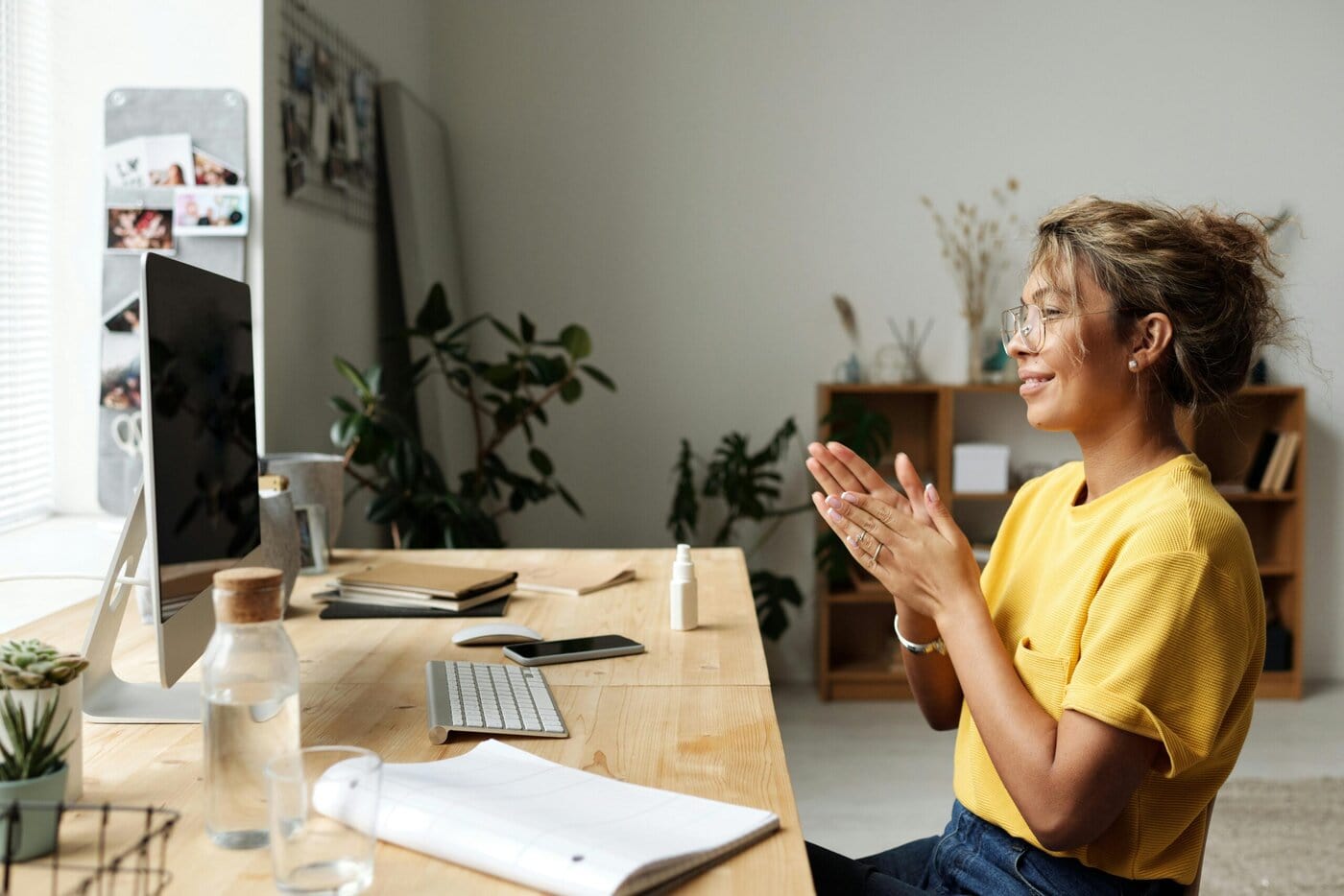 woman-in-yellow-shirt-sitting-on-chair-in-front-of-computer-monitor